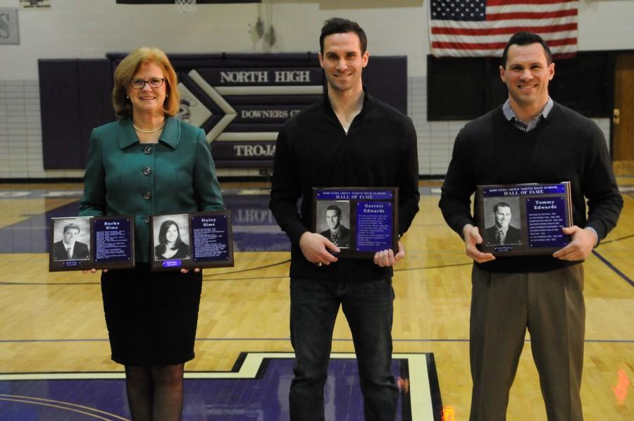 POSING WITH THEIR PLAQUES: Club swim coach Judy Busse accepts athlete hall of fame awards for Burke and Haley Sims alongside Garrett and Tommy Edwards. 