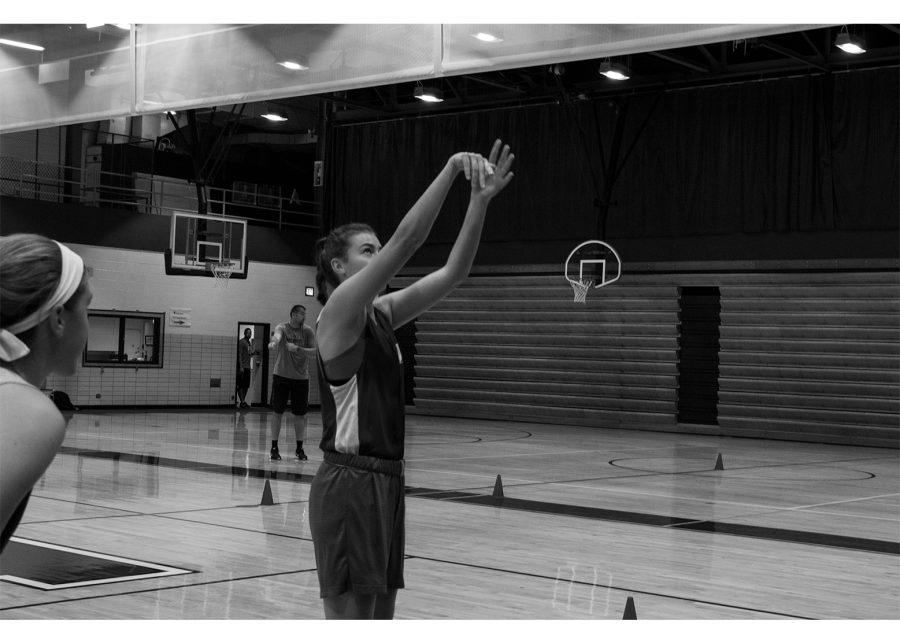 TAKING THE SHOT: Julia Pospislova (11) squares herself to the basket to shoot a free throw. The teams first game will be on Nov. 14, away against Palatine.