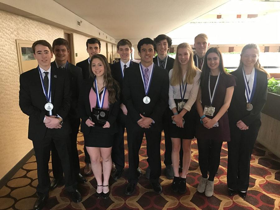 THE BUSINESS OF GOING TO STATE: DECA state qualifiers show off their medals.