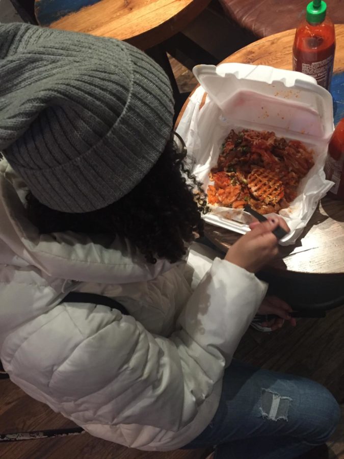 Ciara Asonye (12) digs into a dish of gogi and tacos at Seoul Food restaurant located in Chicago