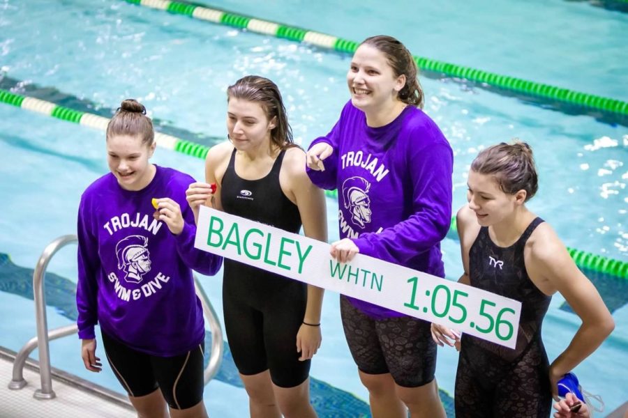 RECORD-BREAKER: Libby Benge (12) holds up the previous pool record for the 100-yard breaststroke, which she broke at the sectional meet Nov. 16.
