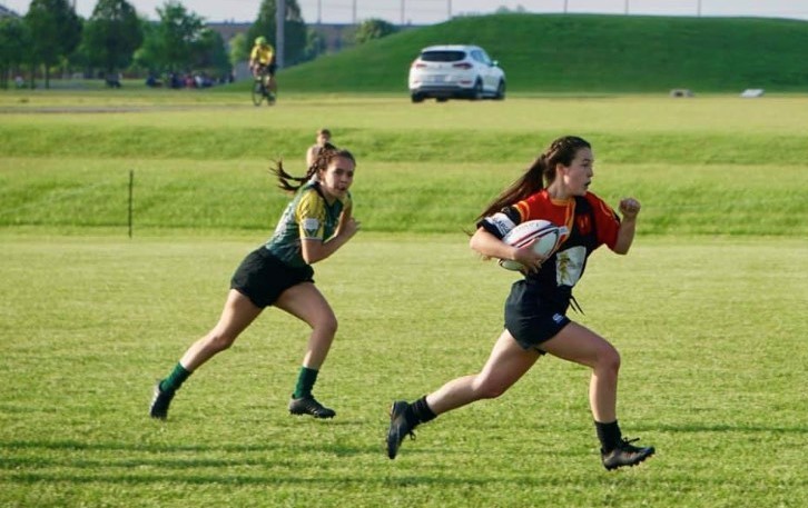 MAKING A MOVE: Elisabeth Delegan (12) rushes out of reach of a defender.