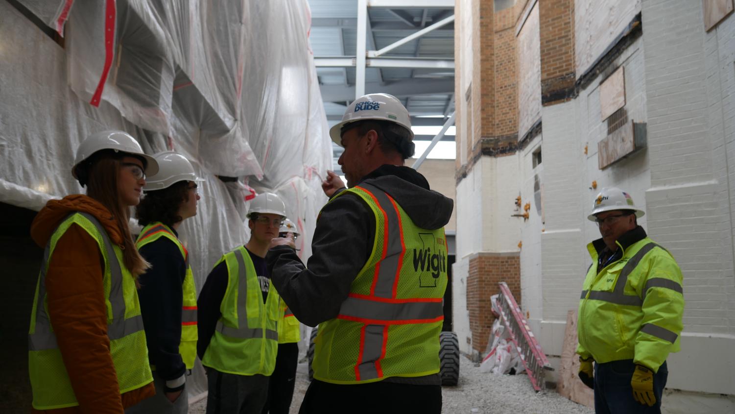 Dr. Sorensen explains where a new door will be located to the Omega staff members.