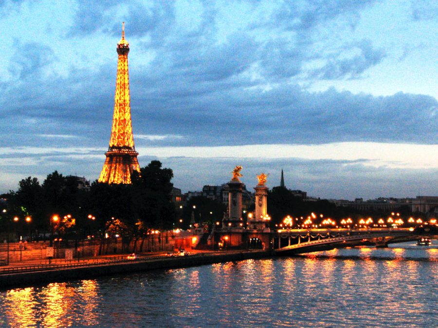 A view of the Eiffel Tower at night from the River Seine.