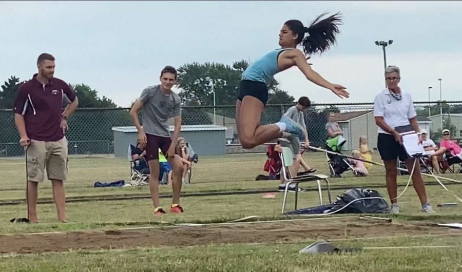 GOING FOR THE RECORD: McKenna Cinotte (12) competes in the triple jump at a July 25 meet.