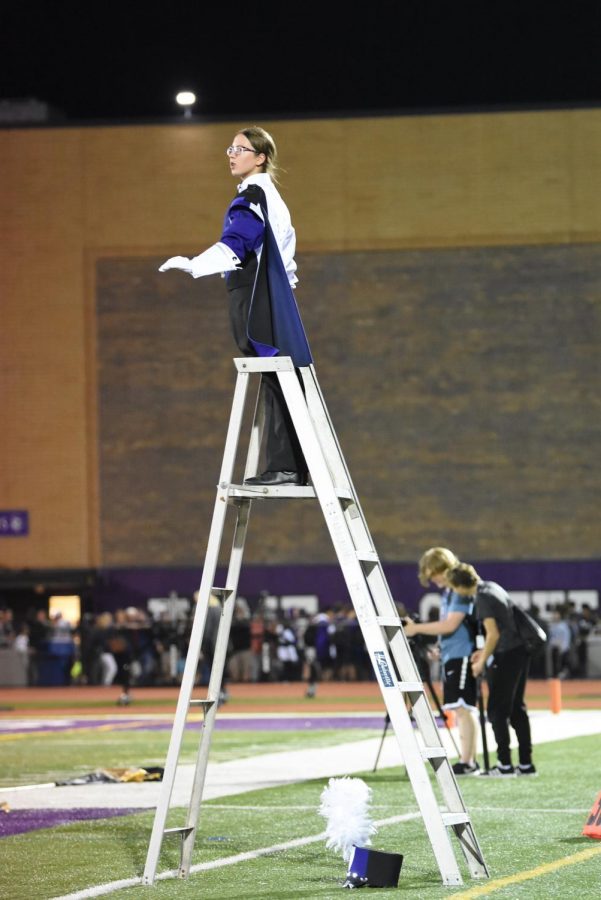 TOP OF THE LADDER: Drum Major Carissa Blumka (12) conducts for the marching band.