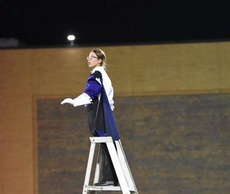 TOP OF THE LADDER: Drum Major Carissa Blumka (12) conducts for the marching band.