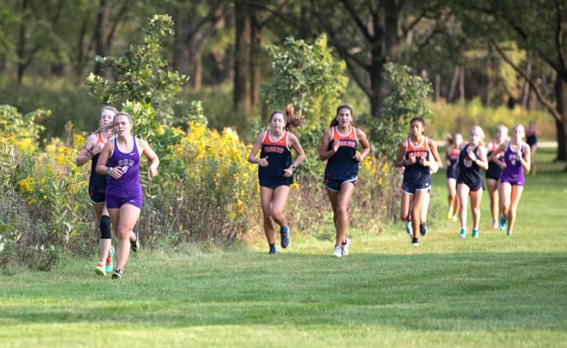 LEADER OF THE PACK: Rylan Gaspar (12) leads a group of runners at home dual meet versus Oak Park River Forest. Dual meets are the only regular season competitions permitted this season in order to comply with COVID-19 safety guidelines. 