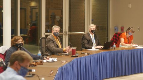 PLANNING FOR THE FUTURE: Dr. Hank Thiele (center left) goes through a presentation at the Board meeting Oct. 19 concerning the return to school.