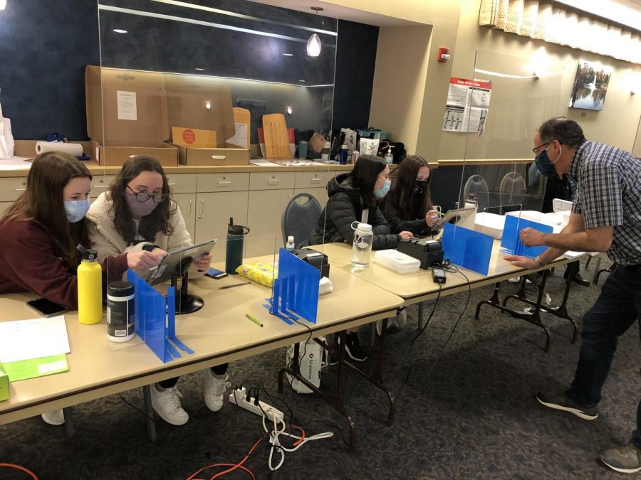 Student judges Gwen Casten and Alexa Hanson seen checking in a voter