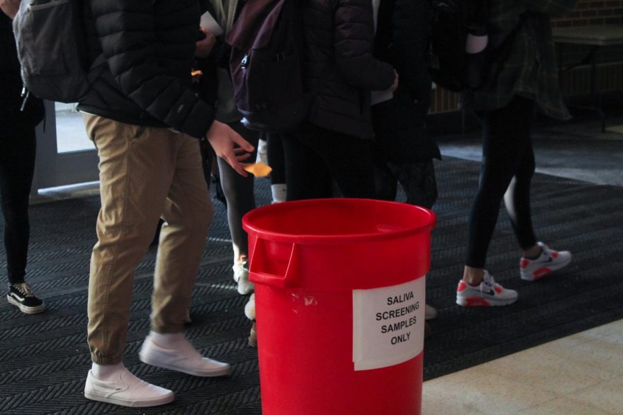 DROP OFF: Students place their saliva tubules in a designated bucket on Feb. 18
