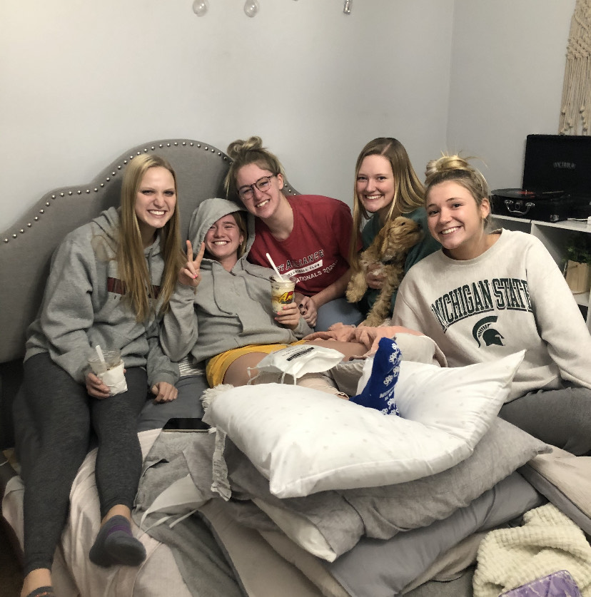 RECOVERING: Junior Ella Sebek rests after ACL surgery with ice cream and friends. 