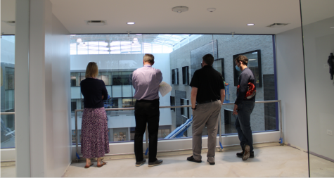 FROM UP ABOVE: future DGN principal Courtney DeMent peers down into the new commons area from a third floor window turing a tour of the campus.