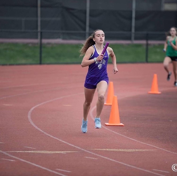PREPARING: Incoming sophomore Karly Harkness runs in a relay at the beginning of the season. 