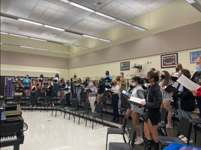 BACK TOGETHER: Treble choir students sing together in risers after a year of separation.  