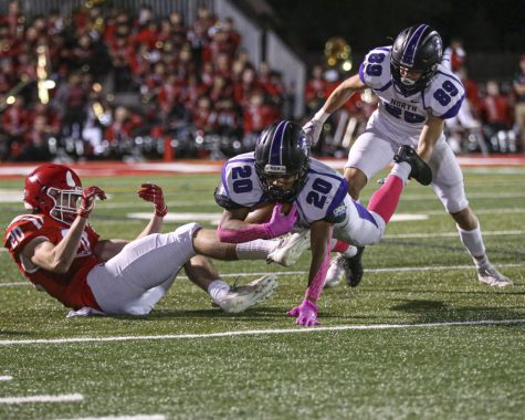 EVERY YARD COUNTS: DGN sophomore running back Noah Battle dives while carrying the ball.