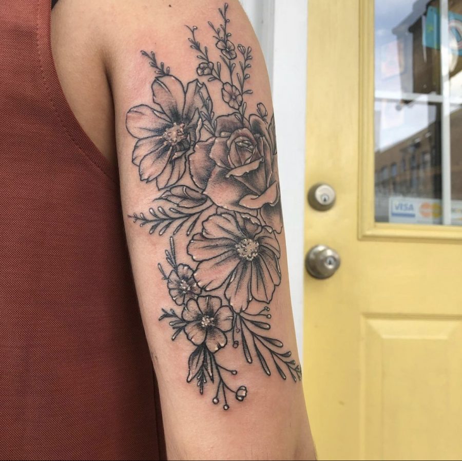 INKED: Math teacher Lucia Torres wears floral art on the back of her arm. 
