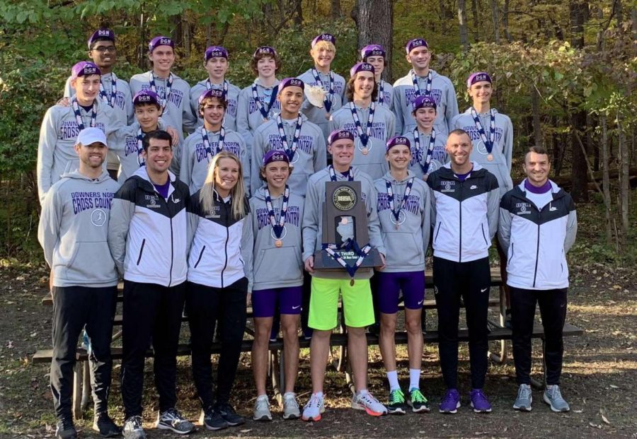 NEW HARDWARE: The boys varsity cross country team shows off their trophy placing third in the state out of 80 teams. 