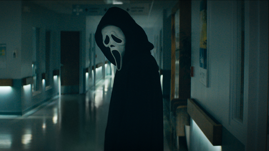 IT’S AN HONOR: Masked murderer Ghostface glares down at a helpless victim in the hallway of a hospital, nearing in for a ruthless kill.