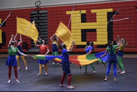 LOOKING UP: Winter guard team members throw double blade tosses during routine. 