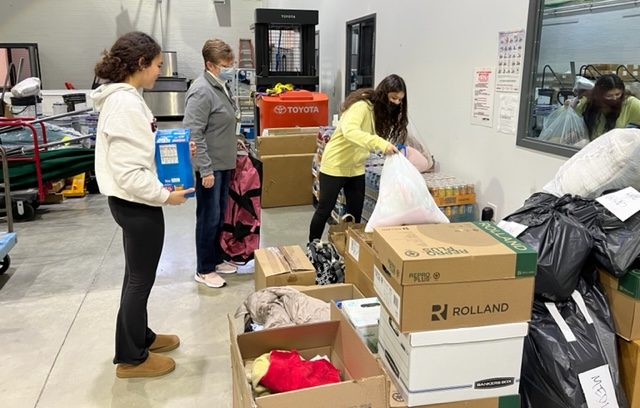 Empowerment Club sponsor Karen Spahr-Thomas and members Jennifer Lucina and Stephanie Baker prepare items from the Ukrainian Donation Drive at the DGN loading dock. According to Spahr-Thomas, the items went to separate locations in Naperville and Bradley, where they were then transported to Ukraine.