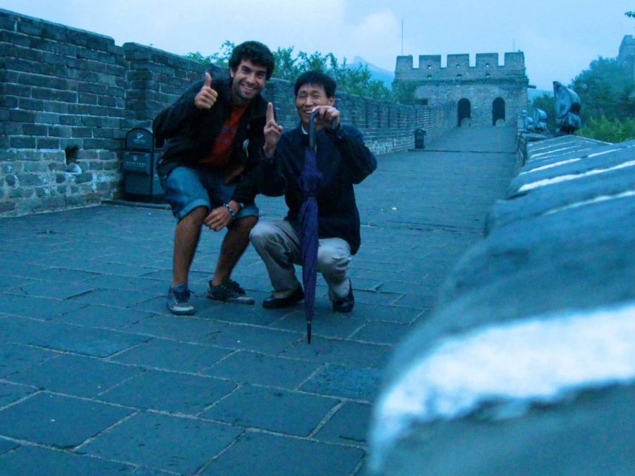 HOPPING THE WALL: Physical education teacher Jose Oleaga visits The Great Wall of China with a new friend. 