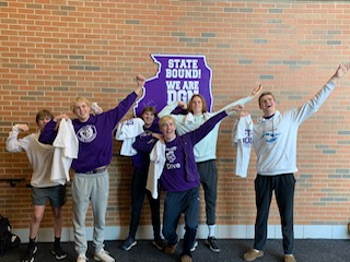 FLEXING: Boys Swim team poses after qualifying for state.