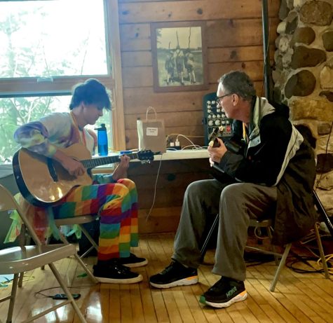STRUM ALONG: Kevin Leslie plays guitar with Snowball director Finn McTigue (senior)