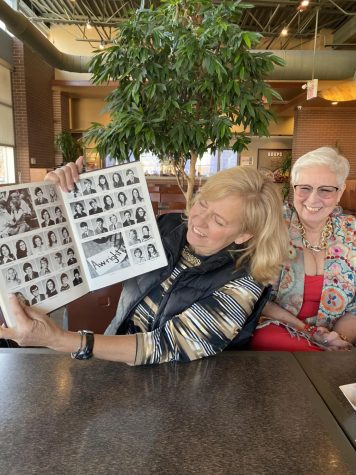 REMINISCING: Delores and Arla look through their old yearbook. 