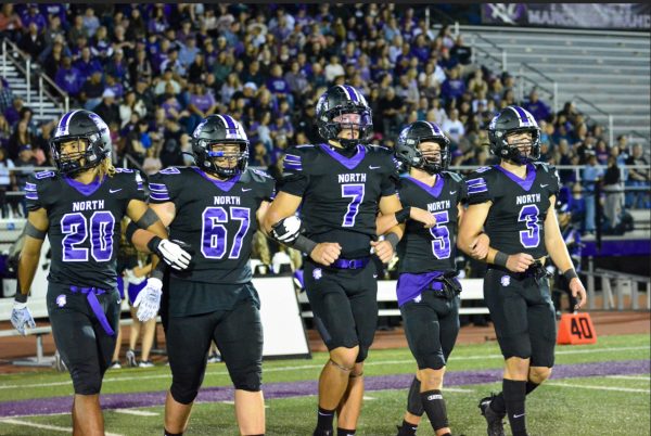 IN IT TOGETHER: Trojan captains Noah Battle (12), Colton Ford (12), Cael Brezina (12), Owen Thulin (12), and Jameson Ordway (12) walk out to the coin toss Sept. 15.
