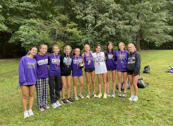 SMILING FOR THE WIN: McKenzie Willard (11) and her teammates pose together after becoming Peoria Notre Dame invitational champions Sep. 16. 