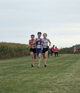 GOING THE DISTANCE: Ryan Eddington (12) outpaces his opponents in the final stretch of the Eddington Invitational. Sep. 16 marked the 53rd edition of the meet.


