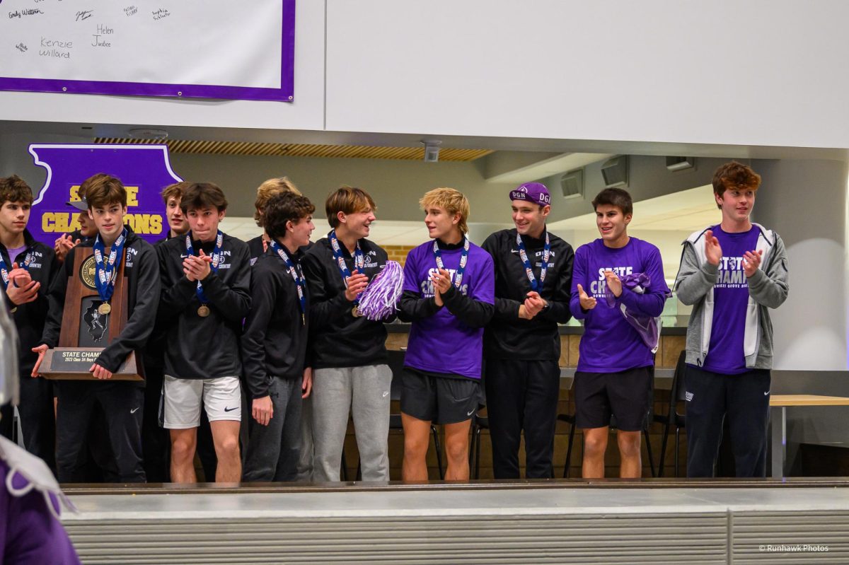 CELEBRATING VICTORY: Downers Grove community gathers to honor the DGN cross country teams state success. The boys cross country team relishes in their first place finish. 