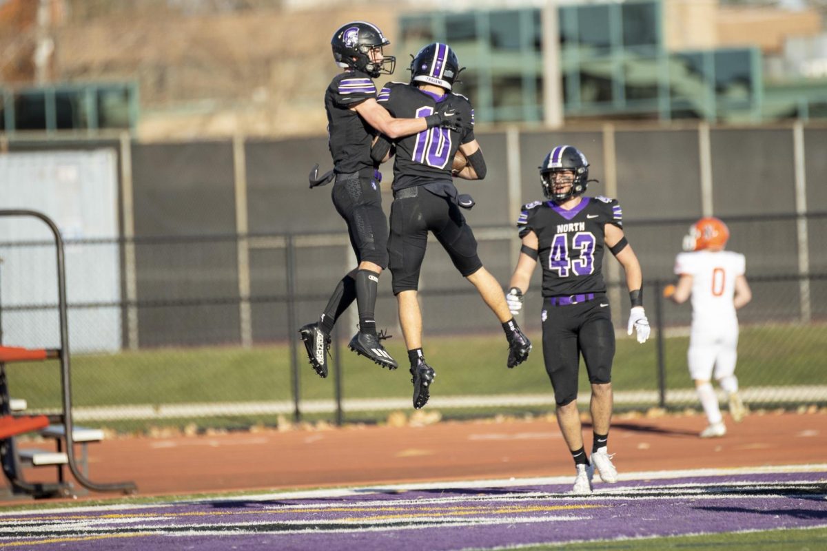 JUMPING FOR JOY: Oliver and Owen Thulin celebrate with each other after  Oliver scores the first touchdown against NCHS Nov. 18.
