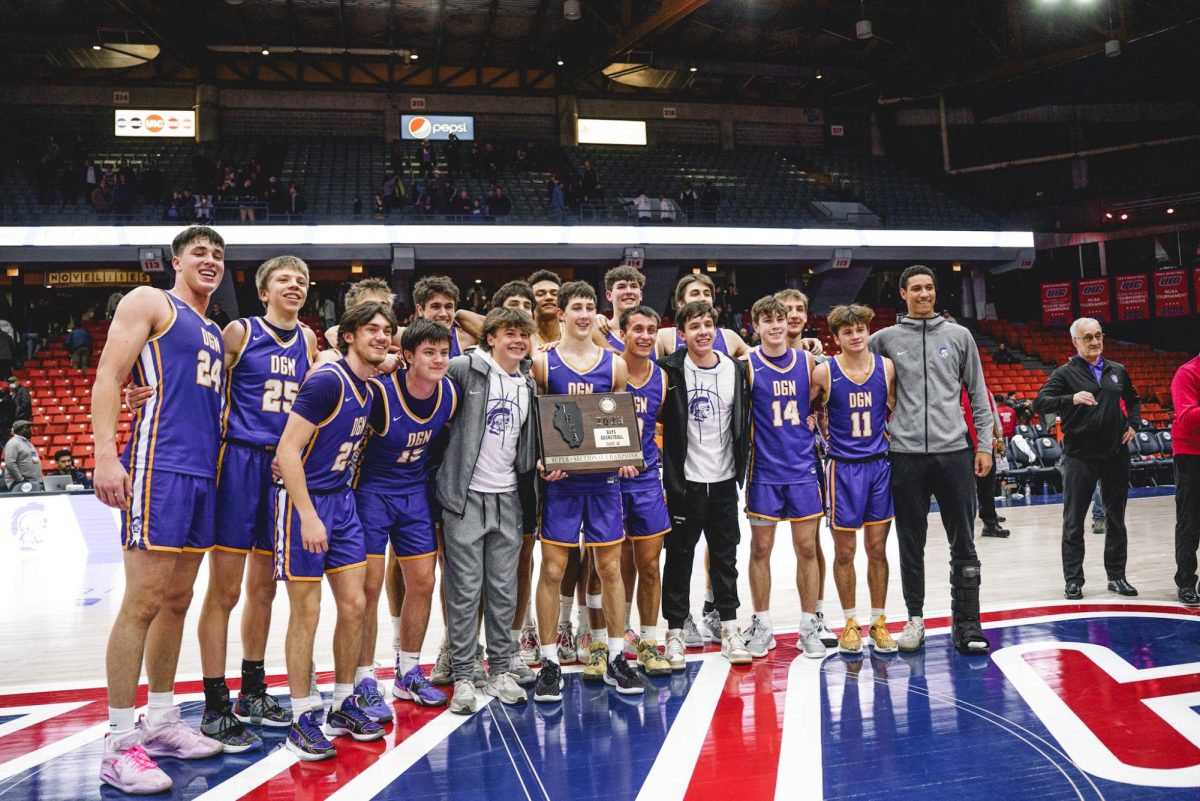 MAKING+HISTORY%3A+The+boys+basketball+team+celebrates+after+beating+Kenwood+Academy+in+the+Super-Sectional+Finals+March+6.+This+marked+the+programs+first+time+advancing+to+the+Final+Four.