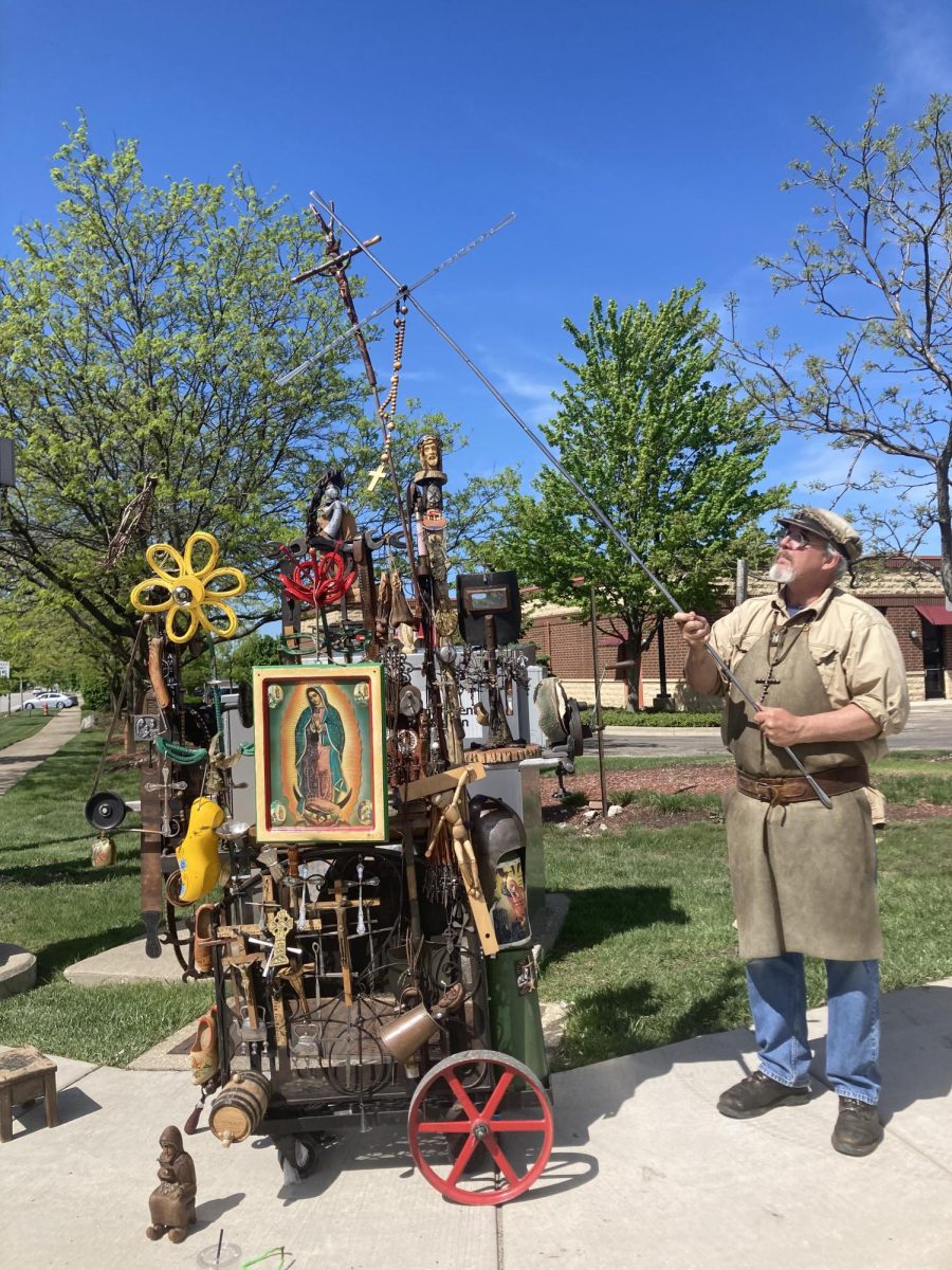 WALKING WESTMONT: Randell Richey and his cart full of his art on Cass Ave.